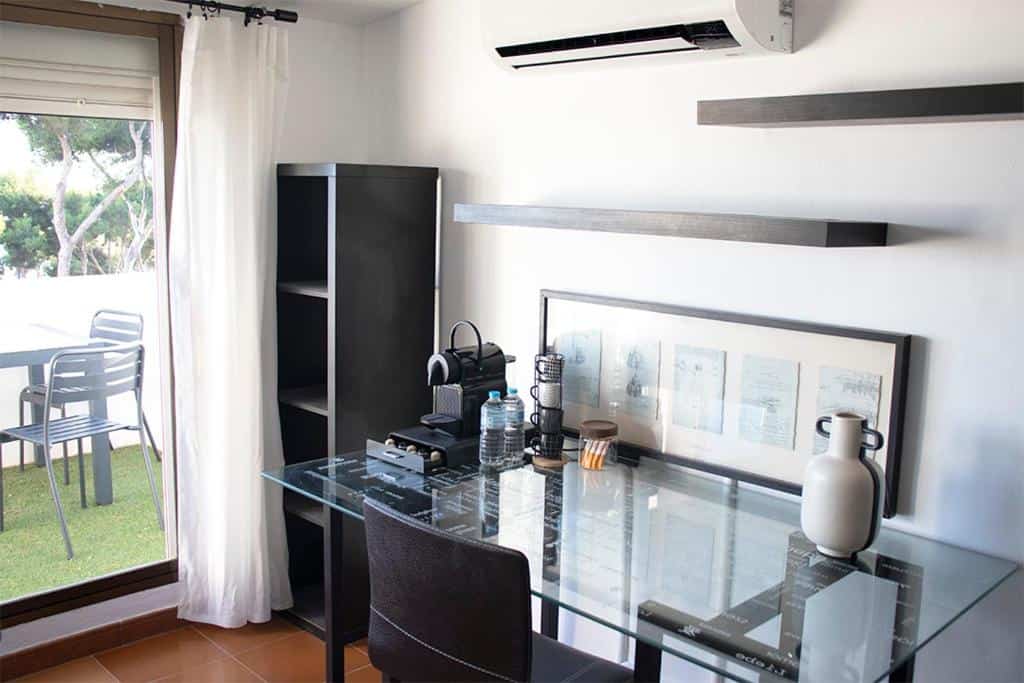 Modern interior of a luxury villa in Málaga with a glass dining table and sea view balcony