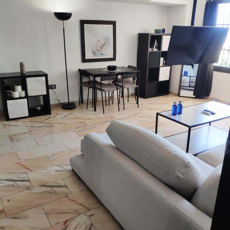 Modern living room in luxury apartment with flat-screen TV and stylish decor