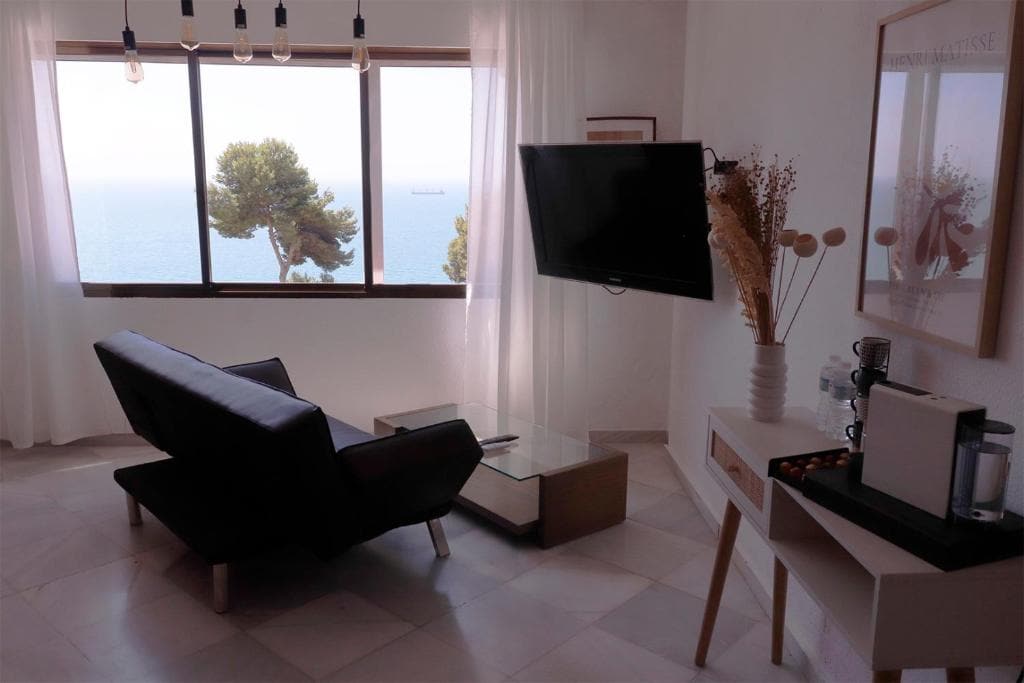 Serene living room with sea views, modern furnishings, and relaxing atmosphere in Malaga luxury villa.