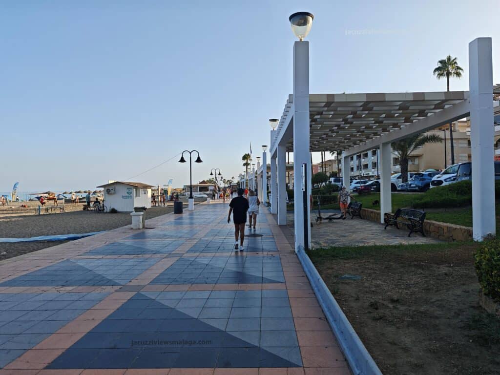 people walking on a sidewalk carihuela promenade