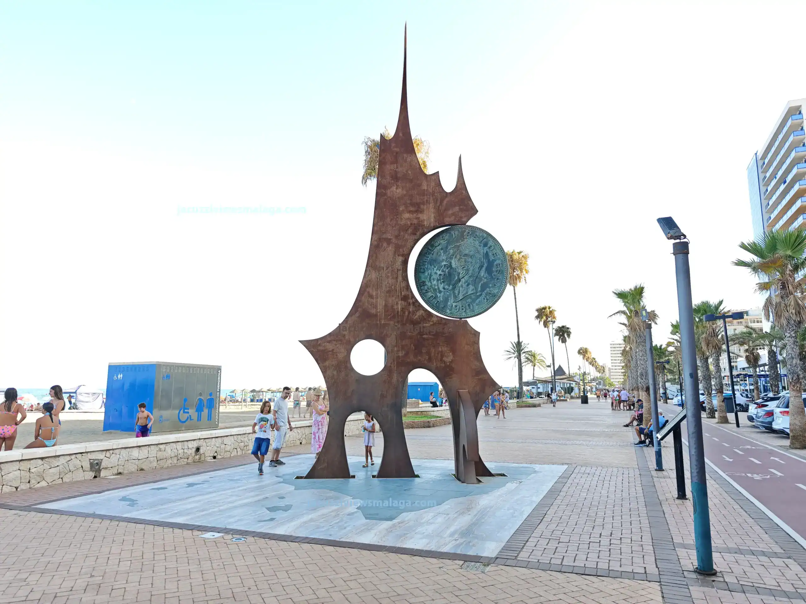 Monument to the Peseta in Los Boliches, Fuengirola – large bronze coin sculpture near Malaga beaches and chiringuitos on the Costa del Sol.