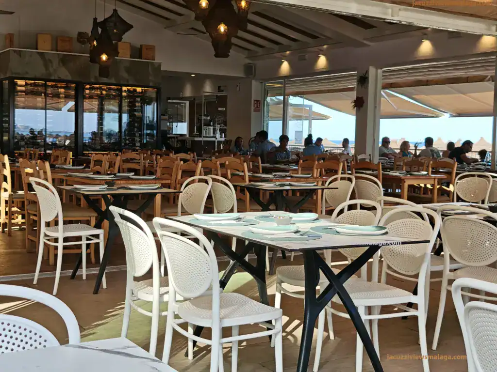 Indoor dining area with sea views at a chiringuito in Los Boliches, Málaga, Costa del Sol.