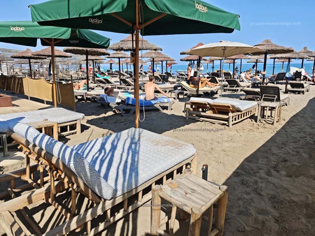 a beach with umbrellas and chairs in los alamos beach