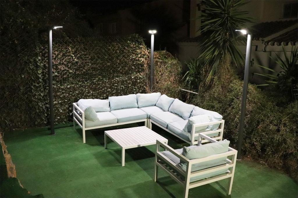 Stylish outdoor lounge with sofa, armchair and lighting at Jacuzzi Views Málaga.